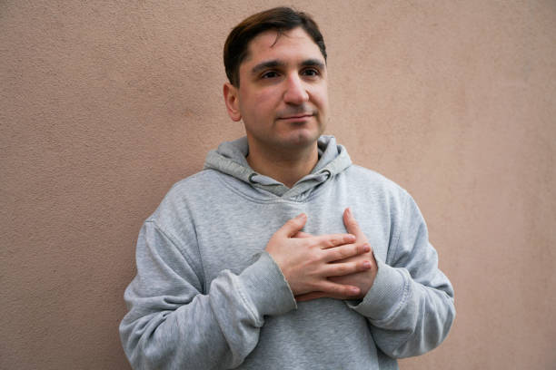 Smiling with hands on chest