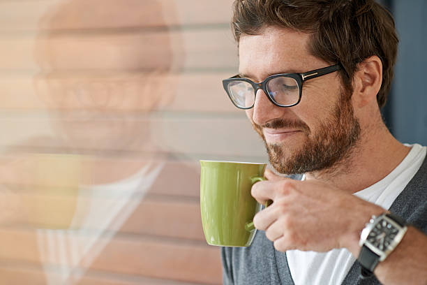 Shot of a young entrepreneur drinking a beverage during a break at work